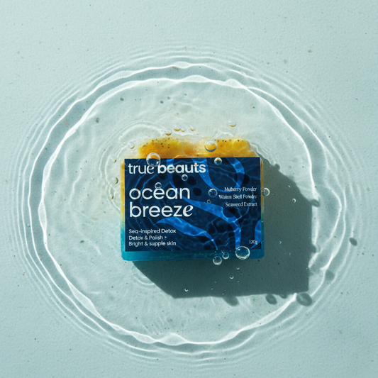 True Beauts Ocean Breeze soap bar in water with bubbles and circular ripples on light blue surface